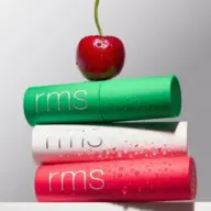 Three rms lip balms stacked with a cherry on top.