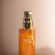 Orange serum bottle with silver pump, labelled "JuiC Multi-C Brightening Serum".