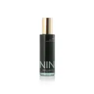 NIN Organics Halo Cleansing Elixir in a black bottle with a gold cap, 100ml.