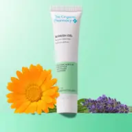 Blemish gel tube with calendula and lavender flowers on green background.