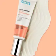Tube of Daily Mineral SPF 30 on a peach background with cream swatch.
