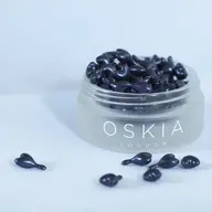 Jar of black skincare capsules labelled "OSKIA London".
