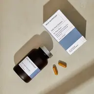 Wild Nutrition Daily Multi Nutrient for Teen Boys bottle, box, and two capsules on a beige surface.