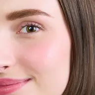 Close-up of a woman's face with smooth skin and text "KIR ROYALE" in the corner.