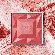 Red blush compact with "rms" logo, surrounded by scattered blush powder.