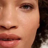 Close-up of a person's face showing smooth skin and natural lip colour.