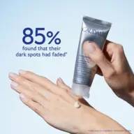 Hand applying Caudalie Vinoperfect cream. Text: "85% found dark spots faded".