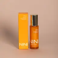 Orange bottle and box of NINI Organics Juicy Multi-C Bio Brightening Serum, 50ml.