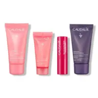 Four Caudalie skincare products in pink and purple tubes and stick.