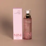 NINI Organics Rose Petal Hydrating Mist, 100ml bottle and pink box on beige background.