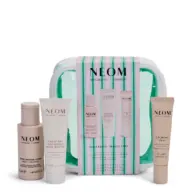 NEOM Wellbeing Travel Edit set with body cleanser, body butter, and calming pen.