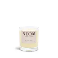 NEOM Bedtime Hero candle with chamomile, ylang ylang, and cedarwood in a glass jar.