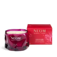 Purple NEOM candle with red box, labelled "Christmas Wish Scented Candle".