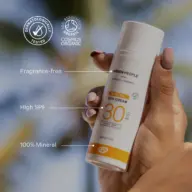 Hand holding Green People SPF 30 mineral sun cream. Fragrance-free, 100% mineral.