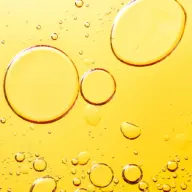 Large and small oil bubbles on a yellow background.