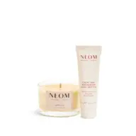 Neom candle and body butter. Candle labelled "Happiness". Body butter labelled "Great Day Magnesium".