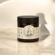 Brown jar of Napiers Herbfstrong Hair Mask on a marble surface.