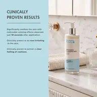 Clinically proven results text with chamomile cleansing milk bottle on marble counter.