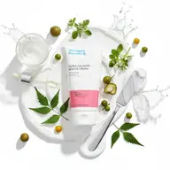 The Organic Pharmacy Ultra Calming Rescue Cream with leaves and glass dropper.