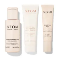 Three NEOM products: body cleanser, magnesium body butter, and calming pen.