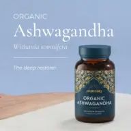 Organic Ashwagandha bottle with decorative label on wooden surface.