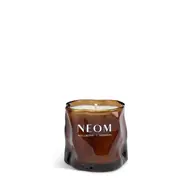 Brown glass candle with "NEOM Wellbeing London" text.