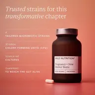 Wild Nutrition Pregnancy + New Mother Biotic bottle with capsule on pink background.