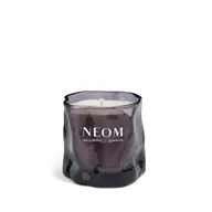 Purple glass candle with "NEOM Wellbeing London" text.