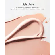 Light Aura text above a smear of champagne-coloured makeup.