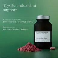 Vitamin B12 Plus bottle with beetroot powder and capsule on green background.