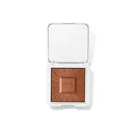 Open compact with bronze powder, "rms beauty" embossed on lid and powder.