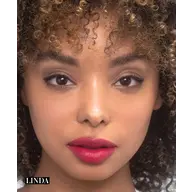 Close-up of a person with curly hair and red lipstick. Text: "Linda" in the corner.
