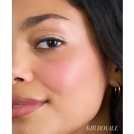 Close-up of a woman's face with natural makeup and text "KIR ROYALE" in the corner.