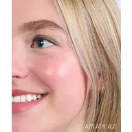 Close-up of a smiling person with blonde hair and text "KIR ROYALE" in the corner.