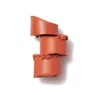 Three stacked slices of terracotta lipstick on a white background.
