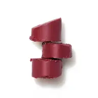 Three stacked slices of deep red lipstick on a white background.