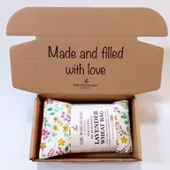 Open box with a floral lavender wheat bag and text "Made and filled with love".