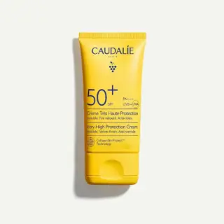 Yellow tube of Caudalie SPF 50+ sun cream with anti-wrinkle protection.