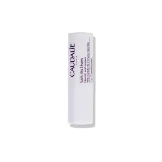 White tube of Caudalie lip conditioner with text on side.