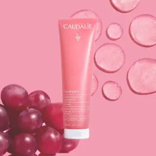 Caudalie VinoHydra Cleansing Gel tube with grapes and pink background.