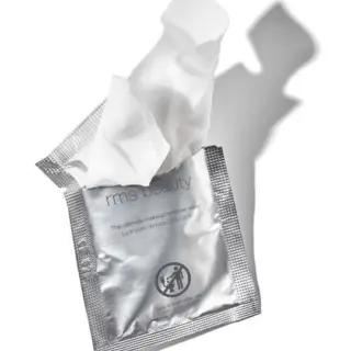 Silver packet of rms beauty makeup remover wipes, partially opened.