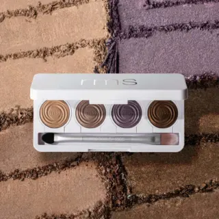 RMS eyeshadow palette with five shades and brush on textured background.