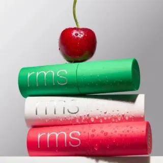 Three rms lip balms stacked with a cherry on top.