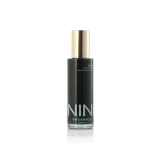NIN Organics Halo Cleansing Elixir in a black bottle with a gold cap, 100ml.