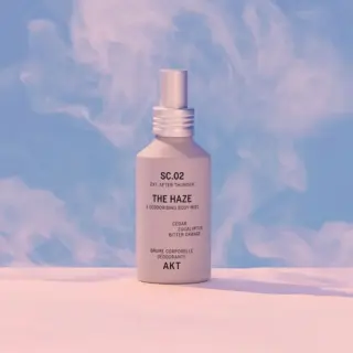 Body mist bottle labelled "The Haze" with cedar, eucalyptus, and bitter orange.