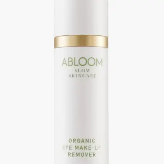 White bottle with gold accents labelled "Abloom Organic Eye Make-Up Remover".