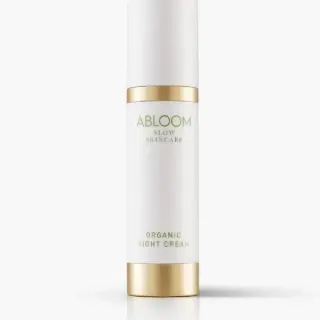 White bottle with gold accents labelled "Abloom Organic Night Cream".