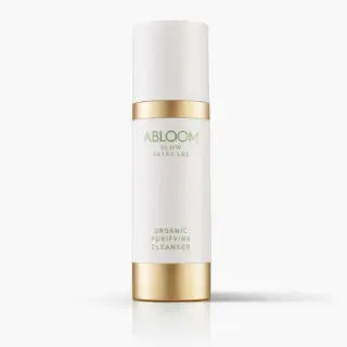Abloom Slow Skincare Organic Purifying Cleanser in a white and gold bottle.