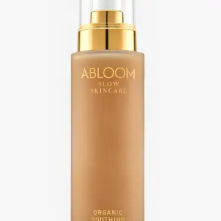 Abloom Slow Skincare Organic Soothing Lotion in a gold-capped bottle.
