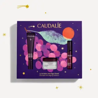 Caudalie skincare gift set with eye cream, serum, and cream on purple grape-themed box.